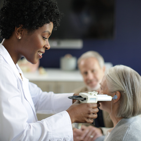 woman taking ear mold for a woman
