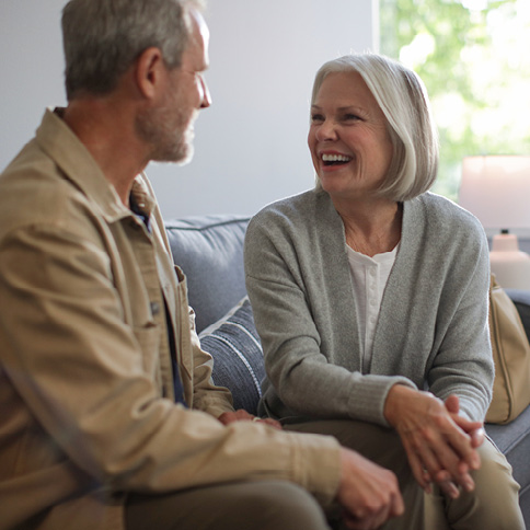 Man and woman talking on a couch