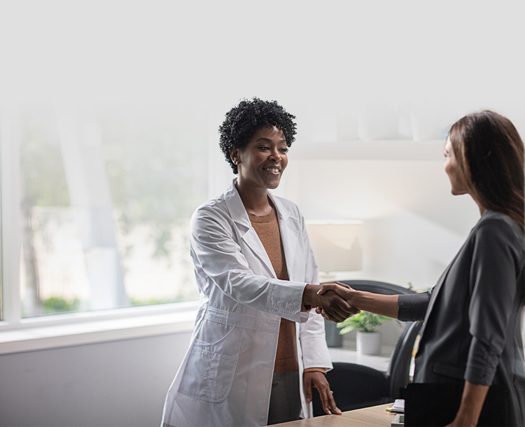 A hearing professional greeting female