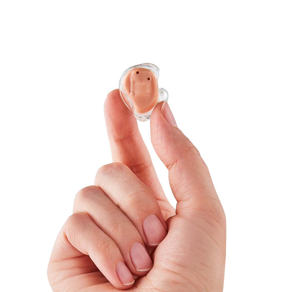 A hand holding a ITE hearing aid
