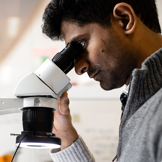 Man looking through a microscope